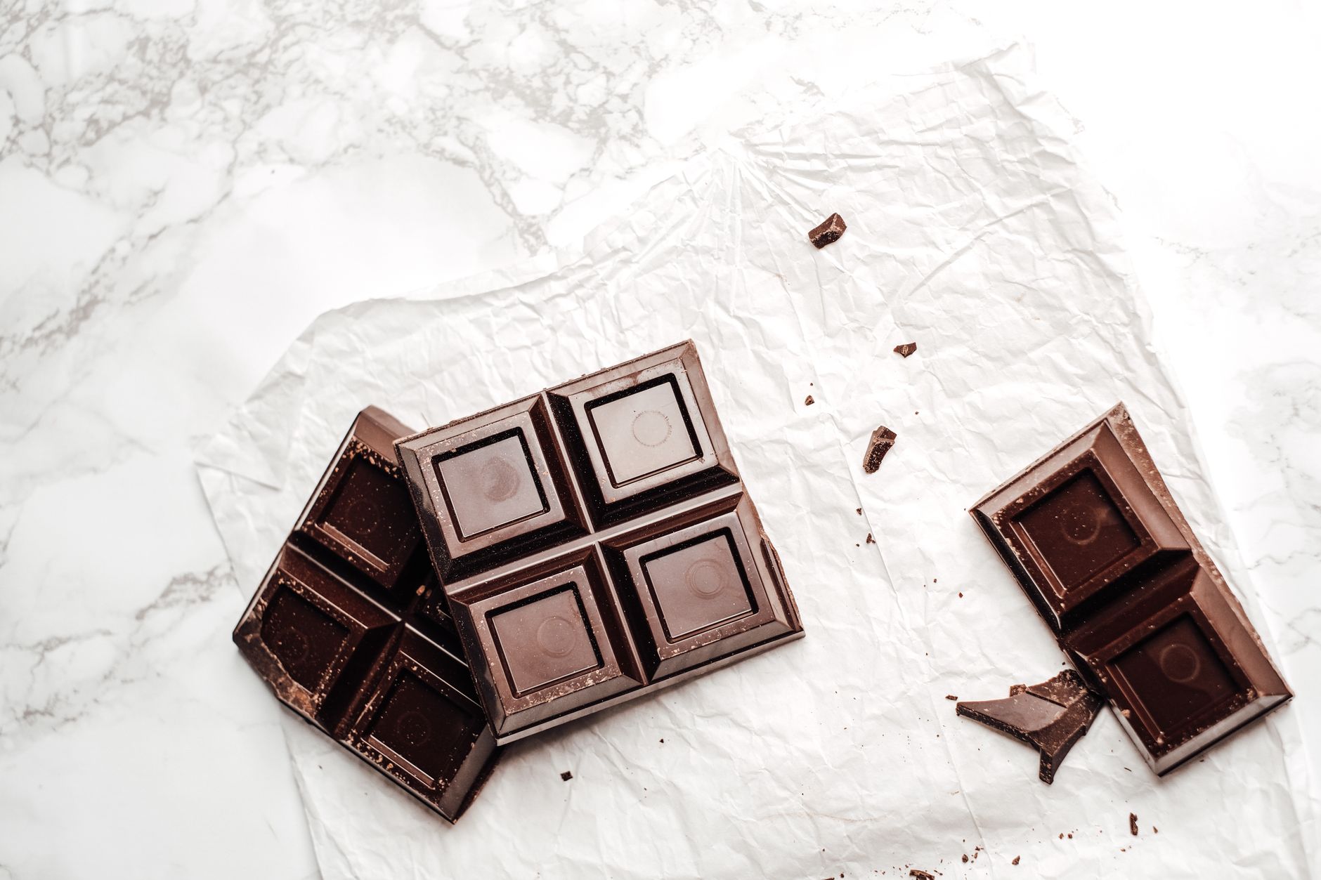 Dark chocolate squares on a wooden board with caffeine content labelled