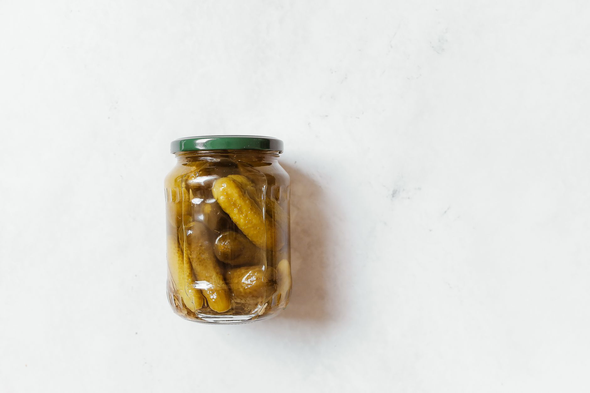 Split image: salty foods (pickles, crisps, olives) on left, sweet foods (chocolate, ice cream, fruit) on right