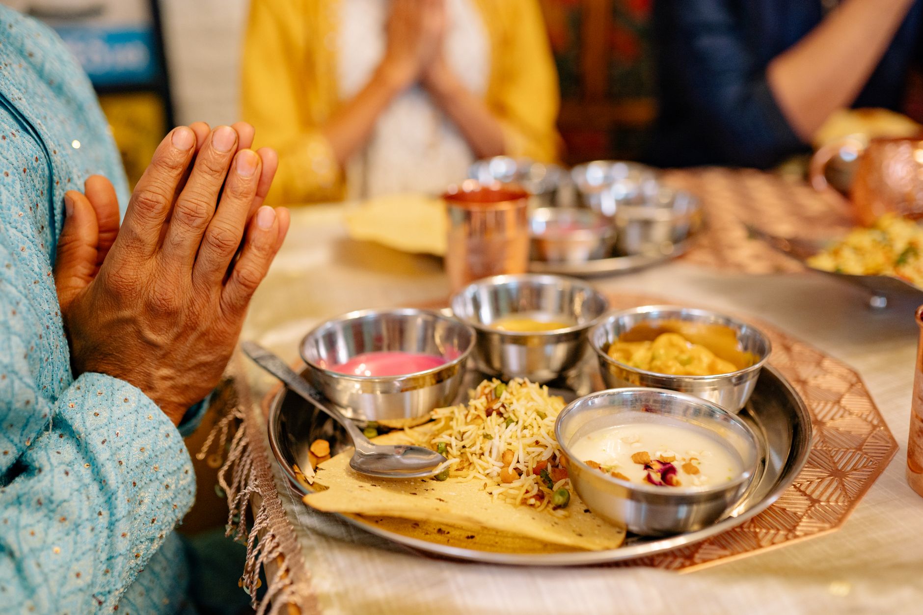 Traditional postpartum jaapa foods — gond ke laddoo, methi laddoo, panjeeri, ajwain water, haldi-doodh — on a brass thali