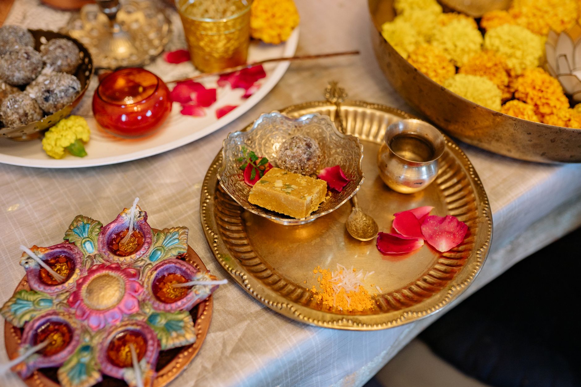 Indian jaapa / confinement plate: panjiri ladoo, methi paratha, dal, gond ke ladoo, dry-ginger powder