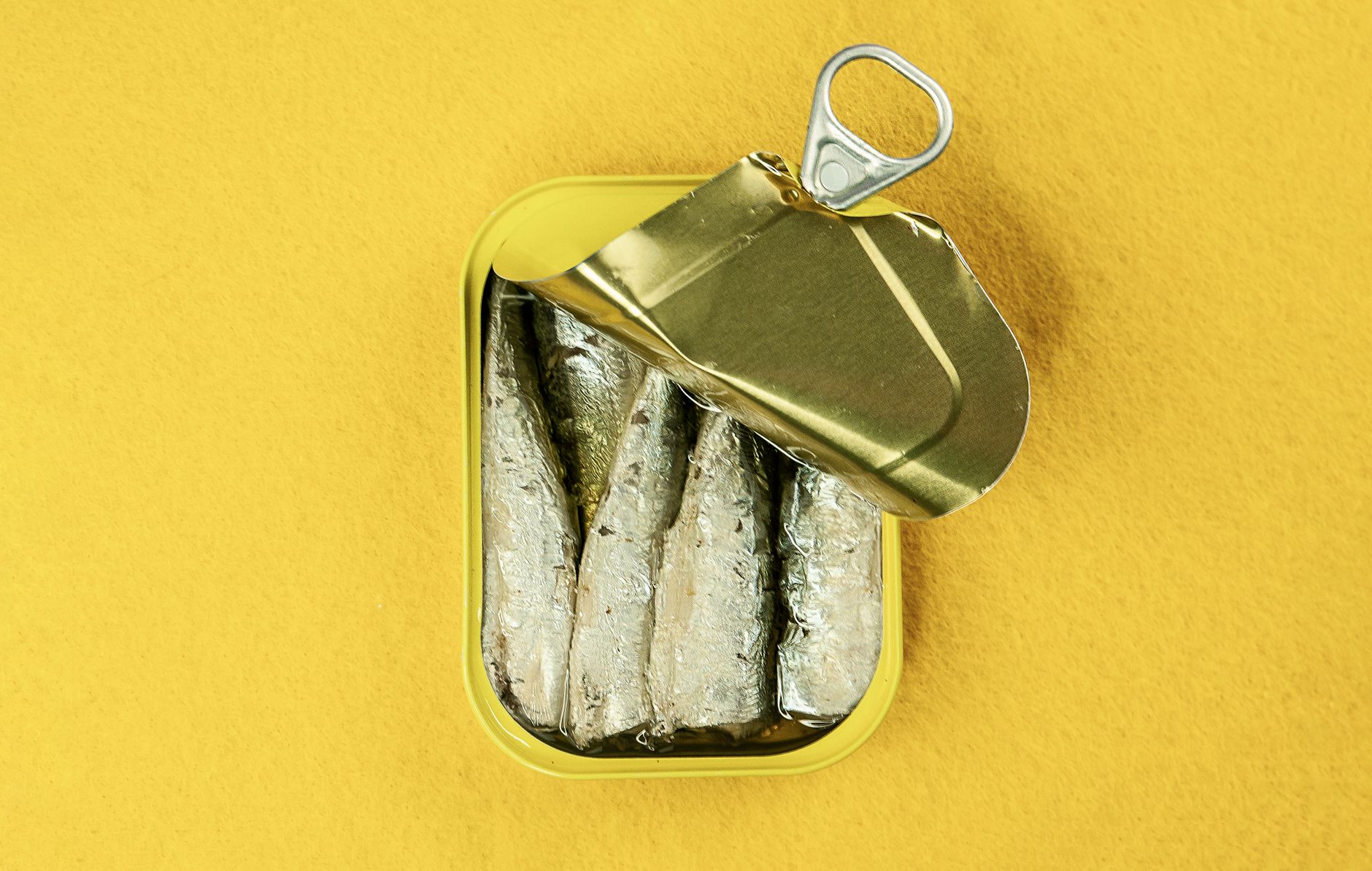 Variety of tinned fish — sardines, mackerel, salmon, tuna — arranged in a 4x grid
